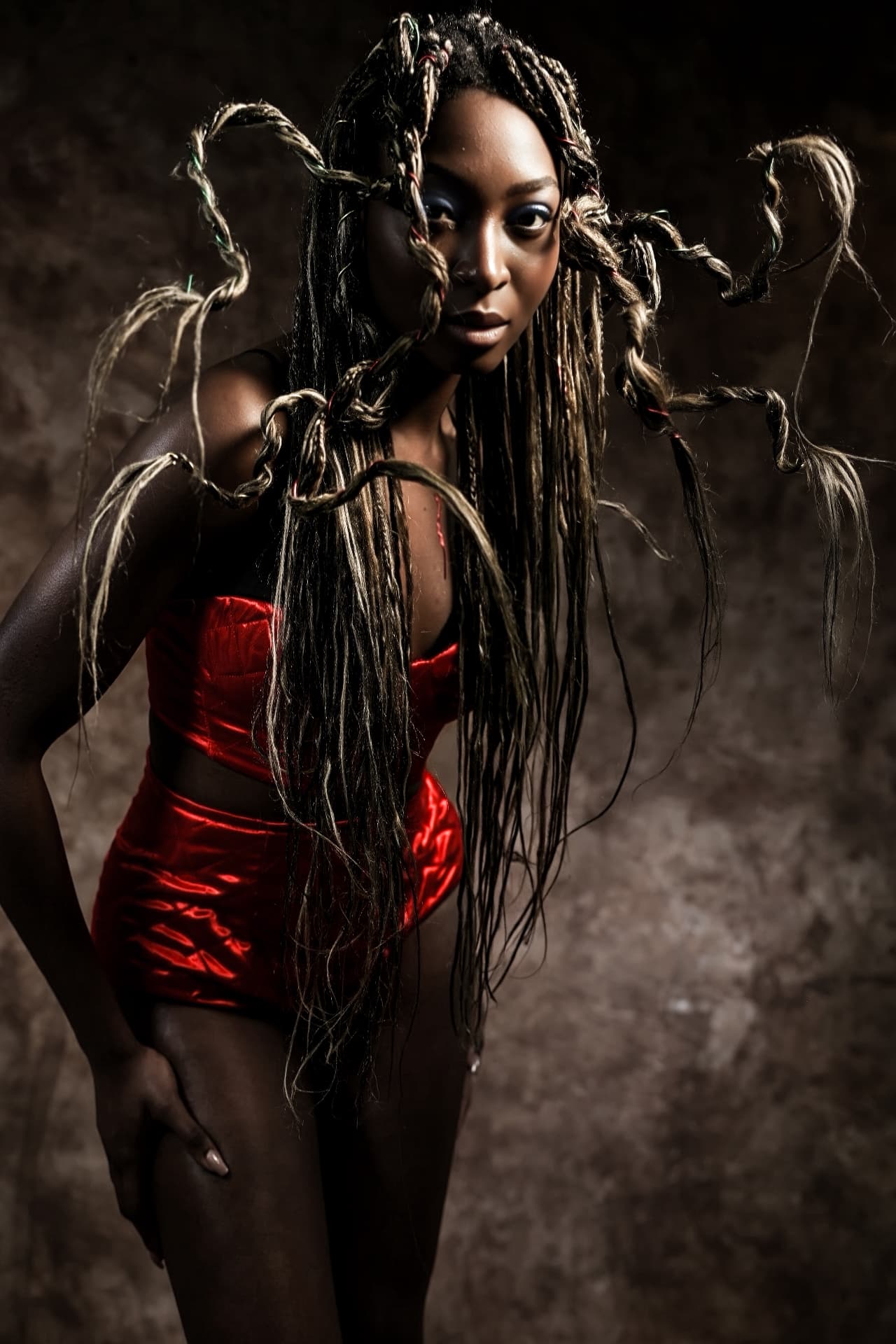Avant-garde pale hair sculpture photographed against dark background