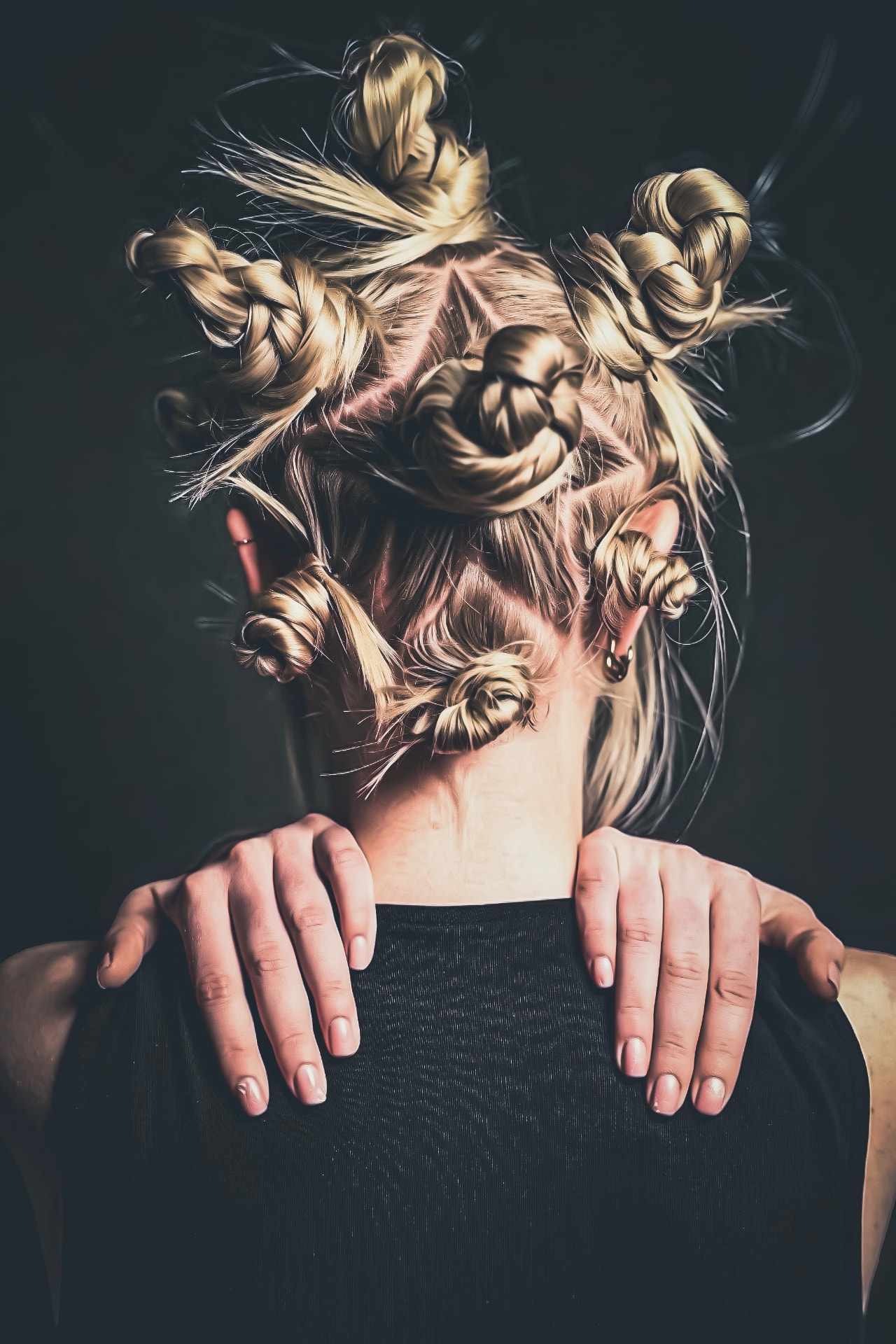 Overhead view of multiple sculpted hair knots and braids