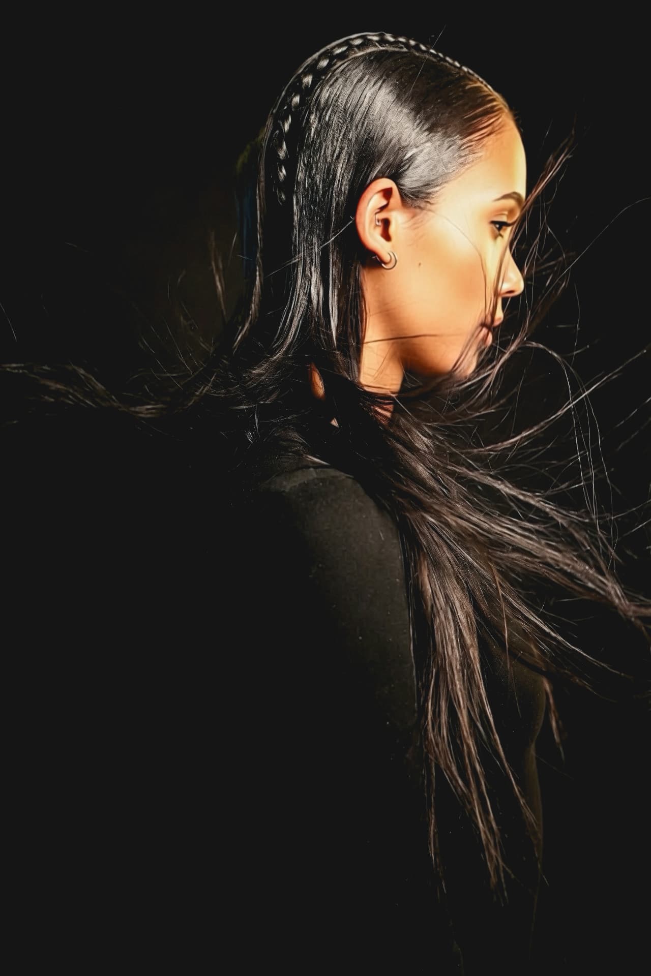 Front view of a dark-haired collection look