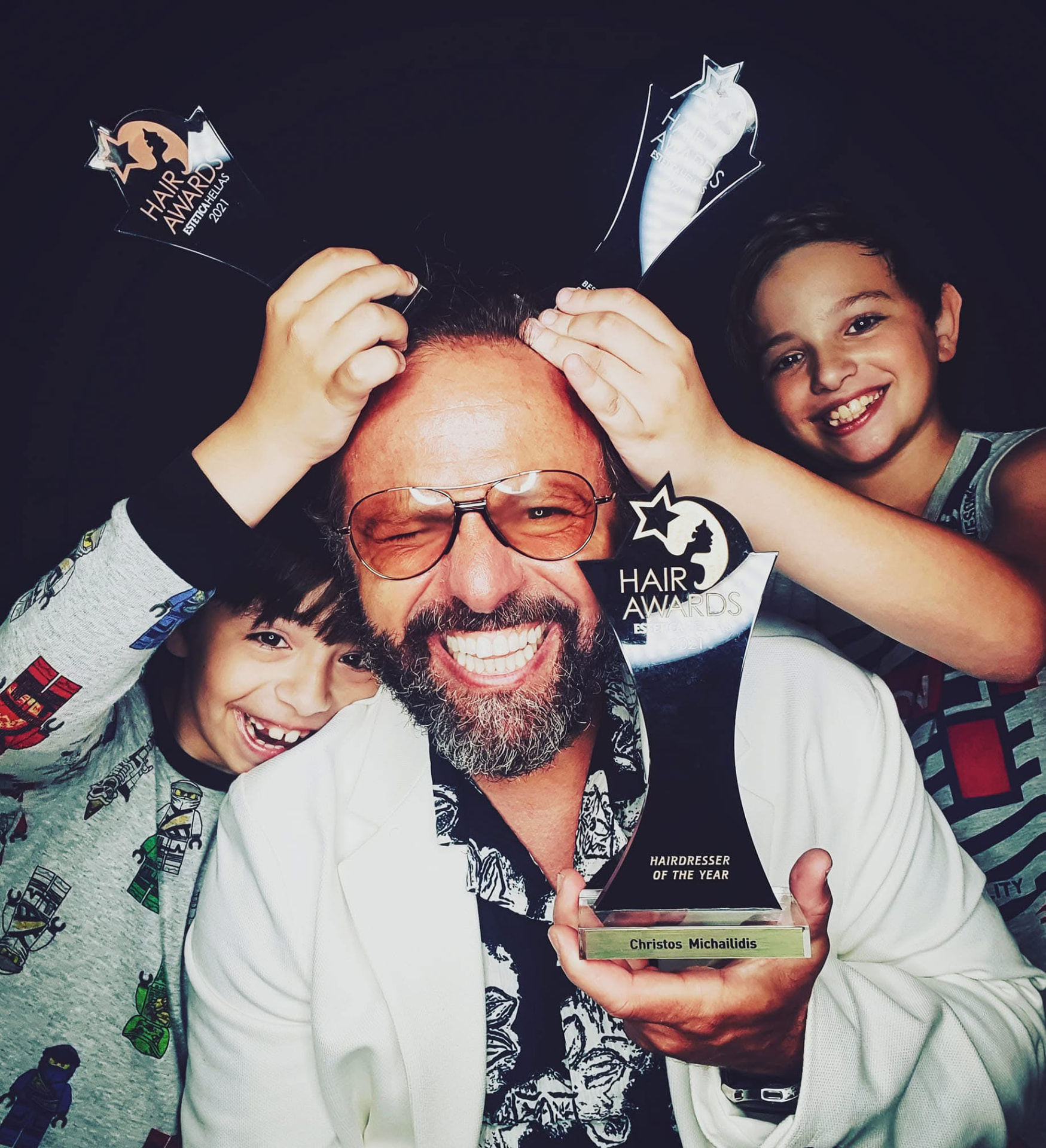Christos Michailidis on stage at a hairdressing awards event